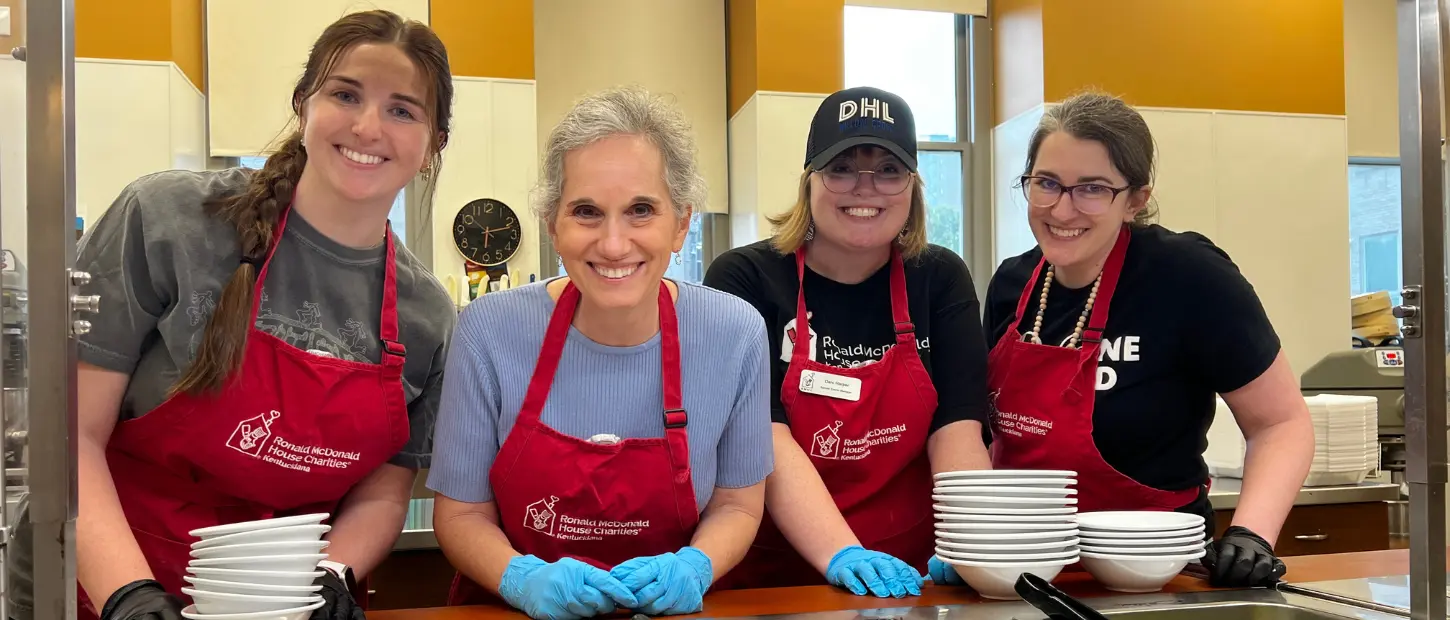 staff members serving food to families